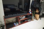 Double bed, tv stand, tv and a work station