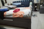 Double bed, tv stand, tv and a work station