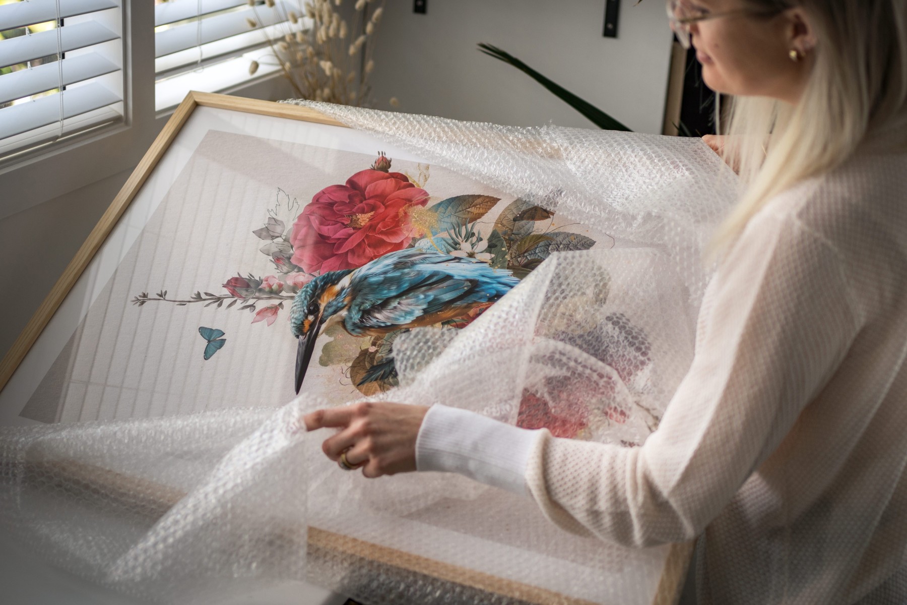 Woman wrapping a framed artwork for moving